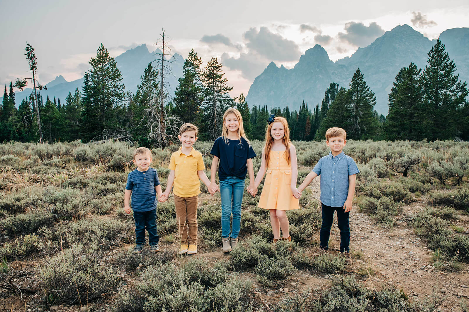 family portrait by mountain in Grand Tetons