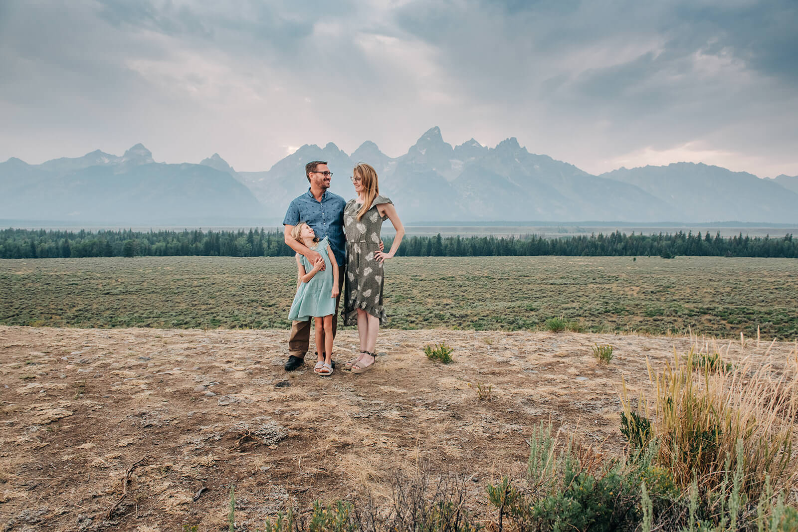 family by mountains in Grand Tetons